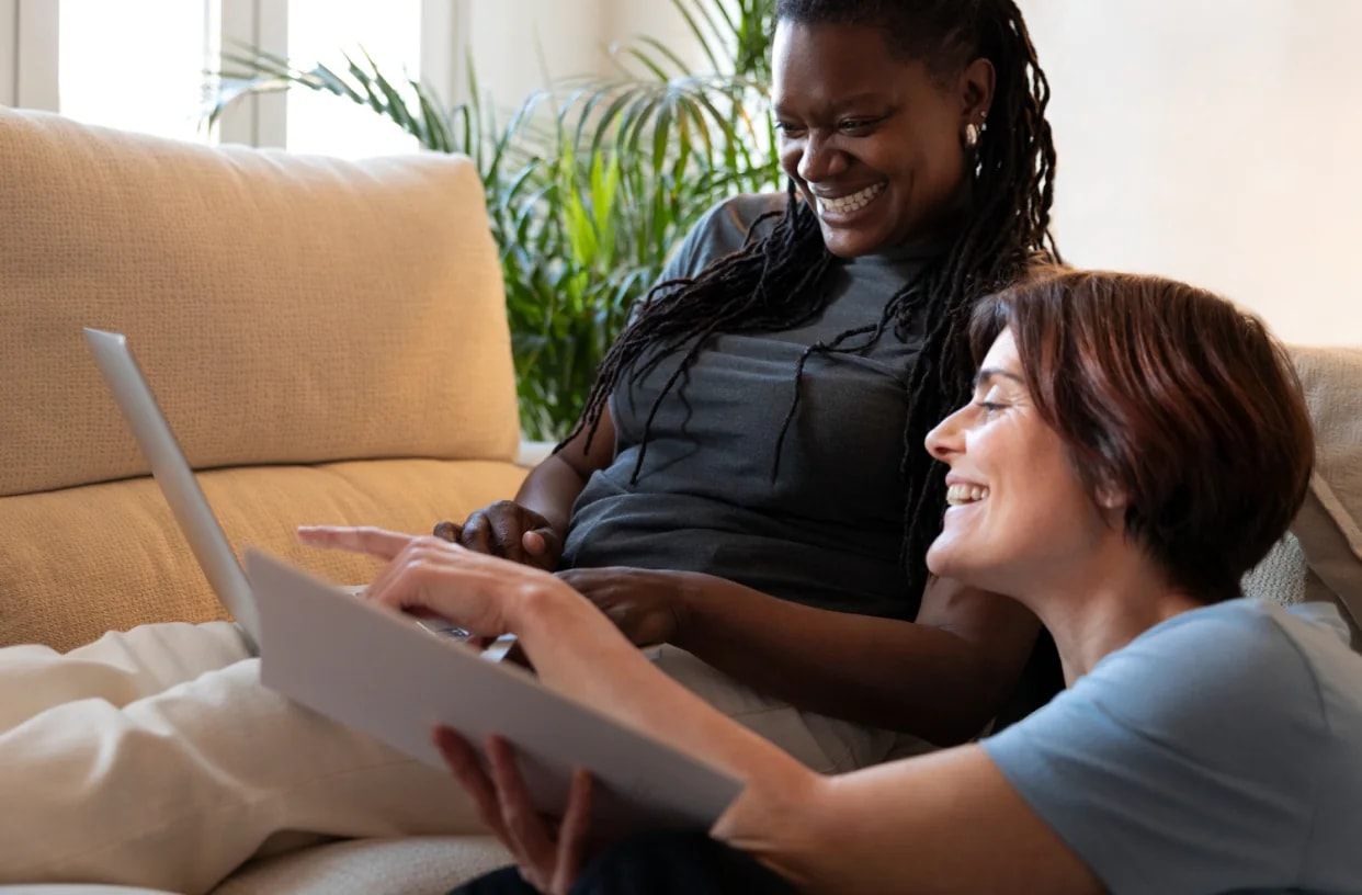 A woman arranging care for her father on a laptop.