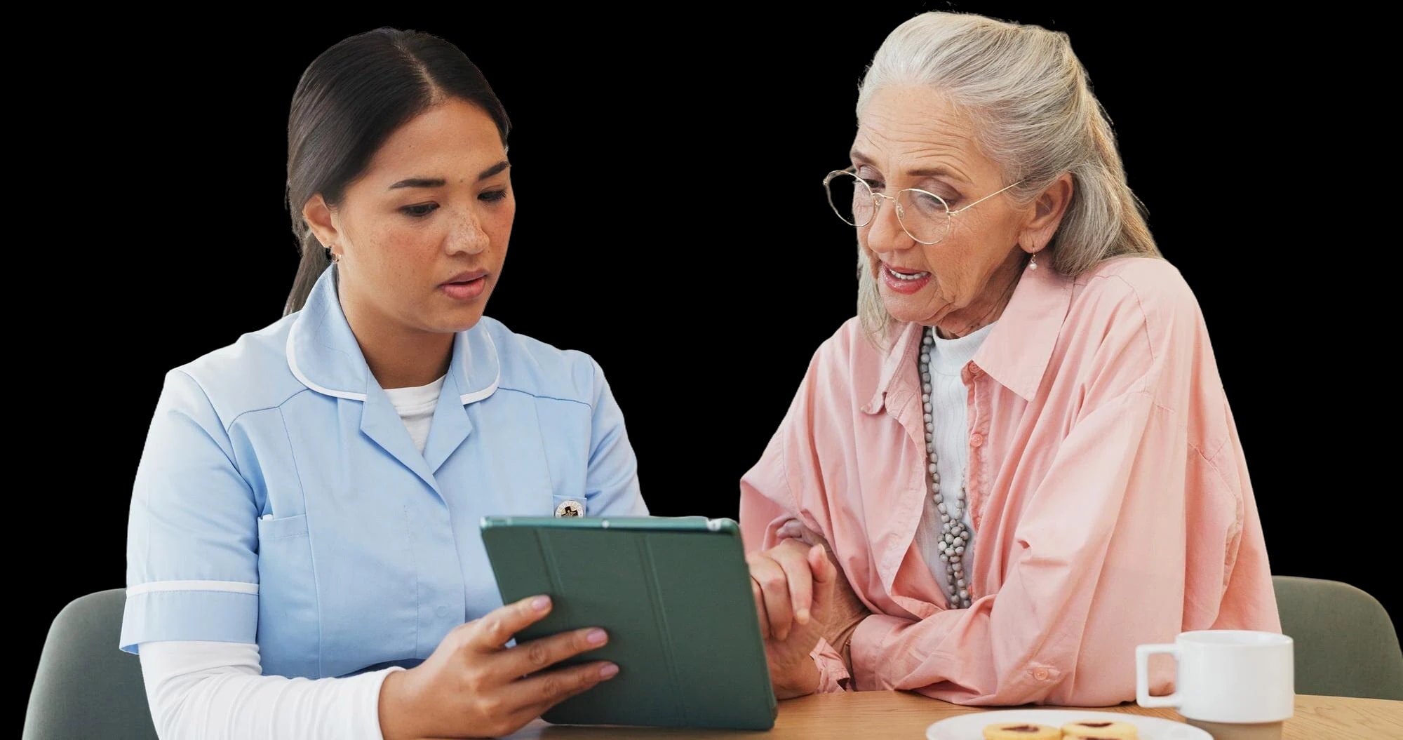A nurse going through notes with an older woman.