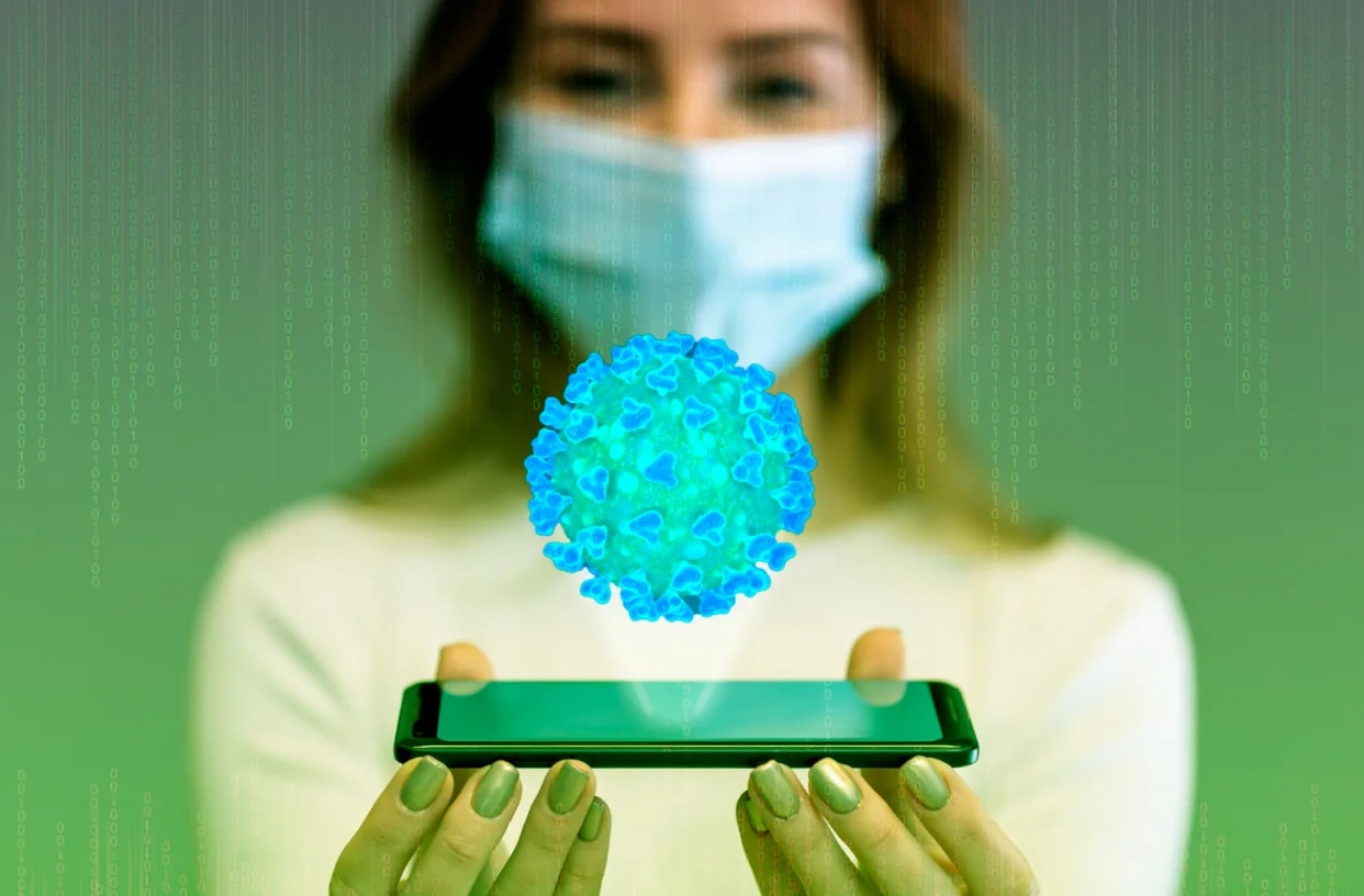 A woman holding a phone projecting a glowing data sphere.